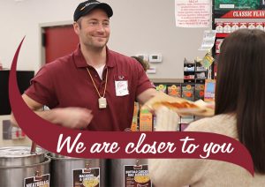 A Stewarts Partner serving a slice of pizza. Text reads We are Closer to You
