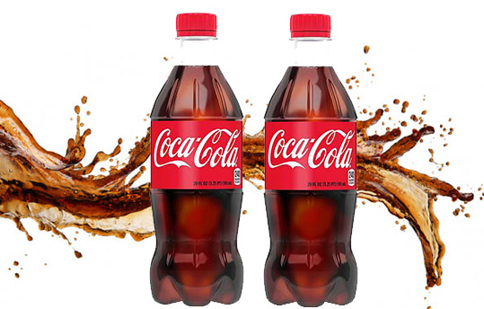 2 bottles of coke with a splash in the background